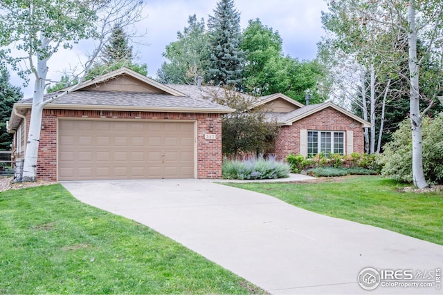 single story home featuring a front lawn and a garage