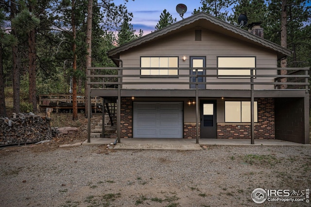 view of front of home featuring a garage and a deck