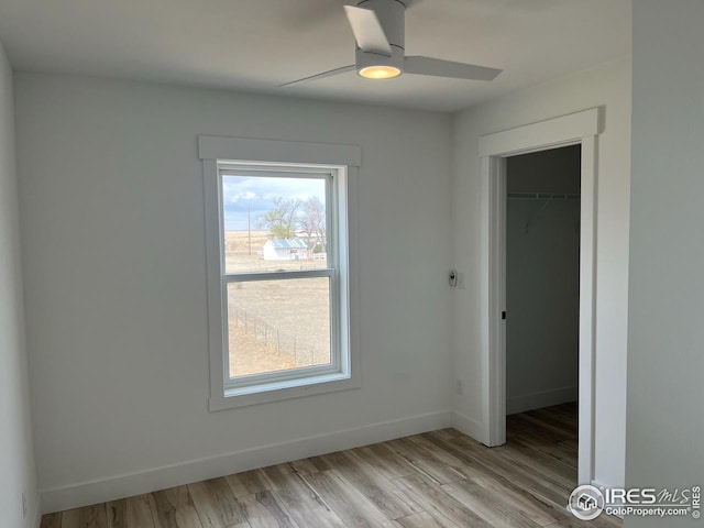 empty room featuring light hardwood / wood-style flooring and ceiling fan