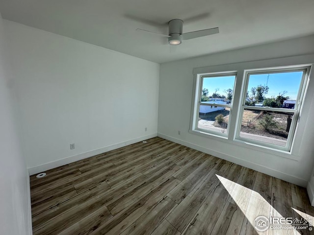 spare room with ceiling fan and dark hardwood / wood-style floors