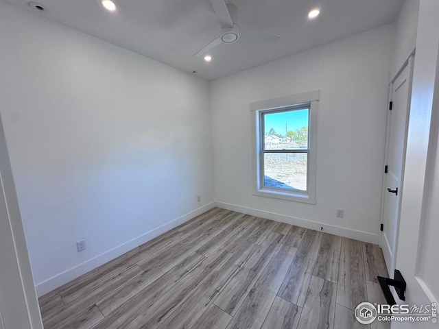 unfurnished room featuring light hardwood / wood-style floors and ceiling fan