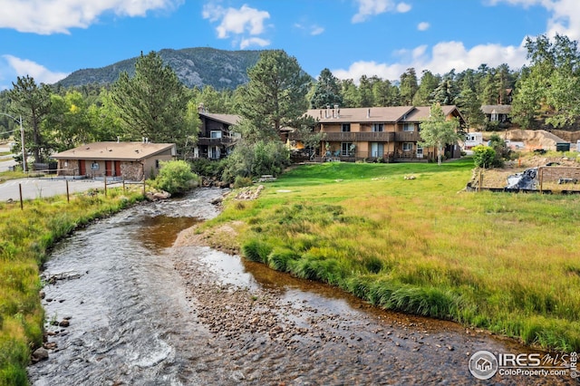 exterior space featuring a water and mountain view