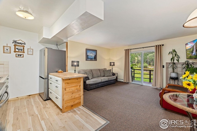 carpeted living room with a baseboard radiator