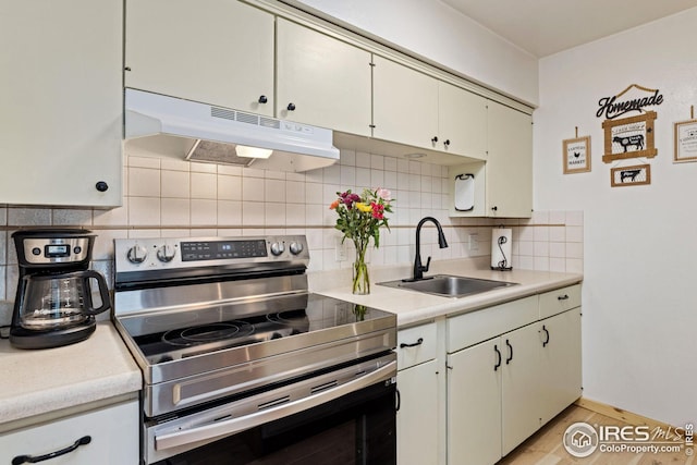 kitchen with sink, backsplash, and stainless steel range with electric cooktop