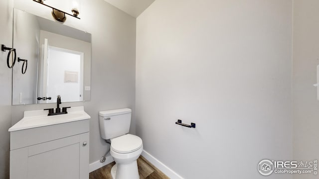 bathroom featuring hardwood / wood-style floors, vanity, and toilet