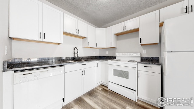 kitchen featuring white appliances, light hardwood / wood-style flooring, white cabinetry, and sink