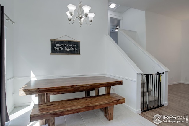 unfurnished dining area featuring an inviting chandelier and light hardwood / wood-style flooring