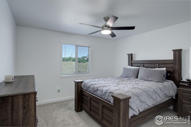 bedroom featuring light carpet and ceiling fan