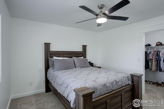 bedroom featuring light carpet, ceiling fan, and a closet