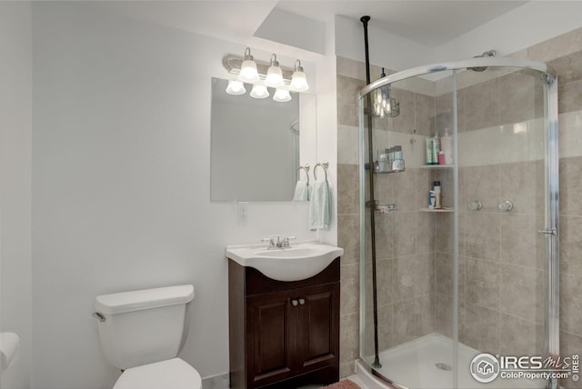 bathroom featuring walk in shower, vanity, and toilet