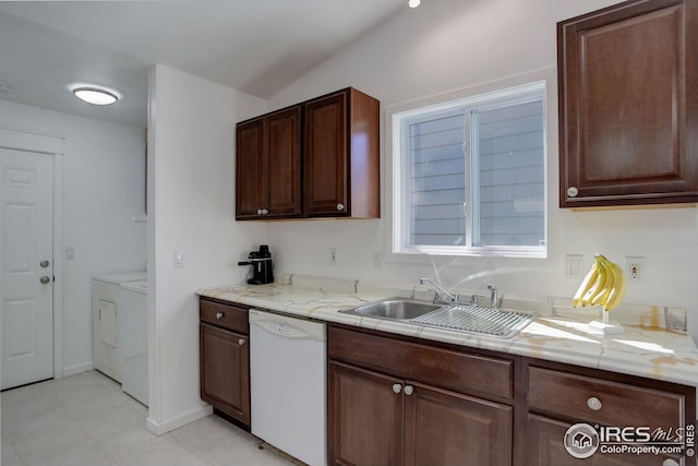 kitchen with dishwasher, light stone countertops, dark brown cabinetry, washer and clothes dryer, and sink