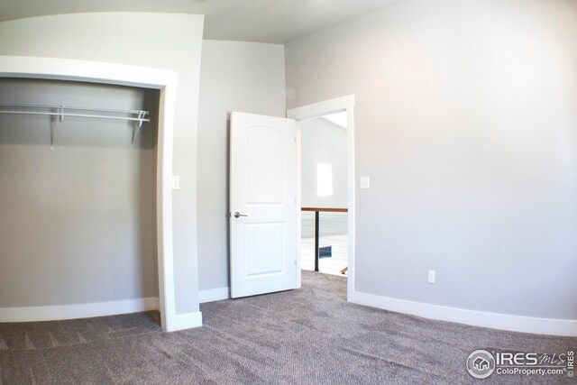 unfurnished bedroom featuring a closet and carpet floors