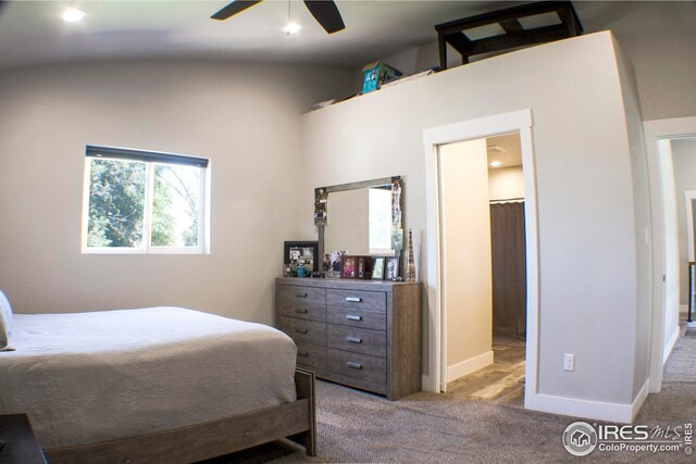 bedroom featuring ceiling fan, carpet, and vaulted ceiling