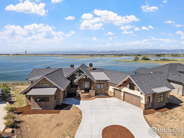 exterior space with a garage and a water and mountain view