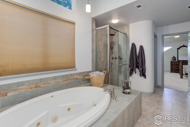 bathroom with tile patterned flooring and separate shower and tub