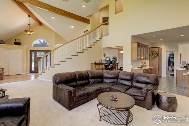 living room featuring high vaulted ceiling, beam ceiling, and carpet floors