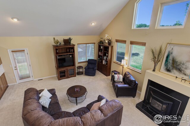 living room with light carpet and high vaulted ceiling