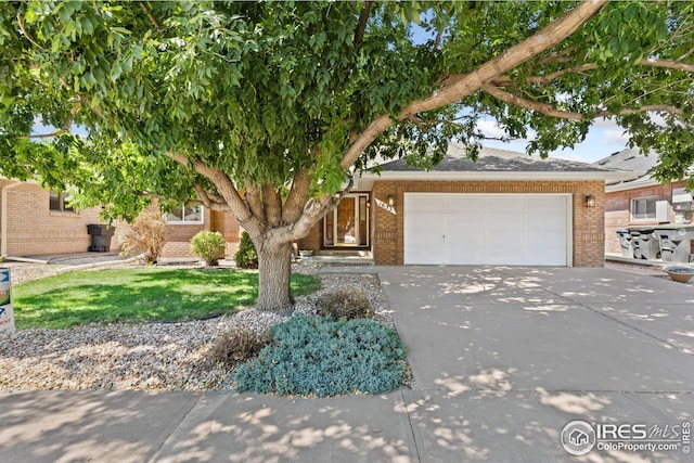 obstructed view of property with a garage