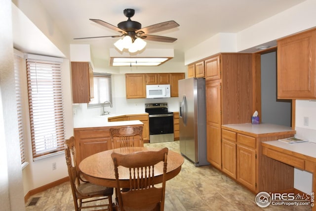 kitchen featuring ceiling fan, sink, and appliances with stainless steel finishes