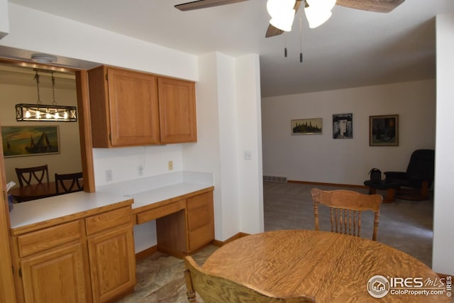 kitchen with built in desk and ceiling fan