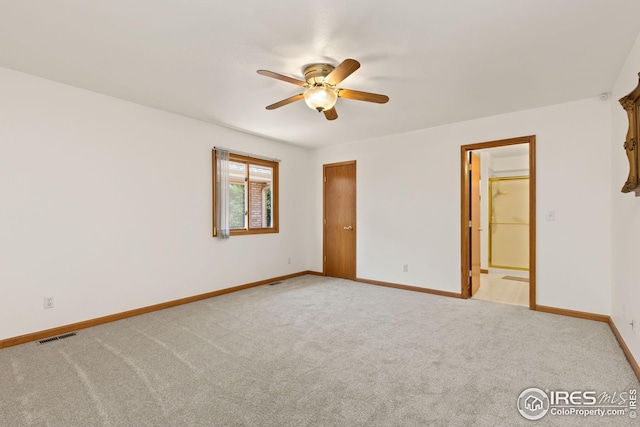 carpeted empty room featuring ceiling fan