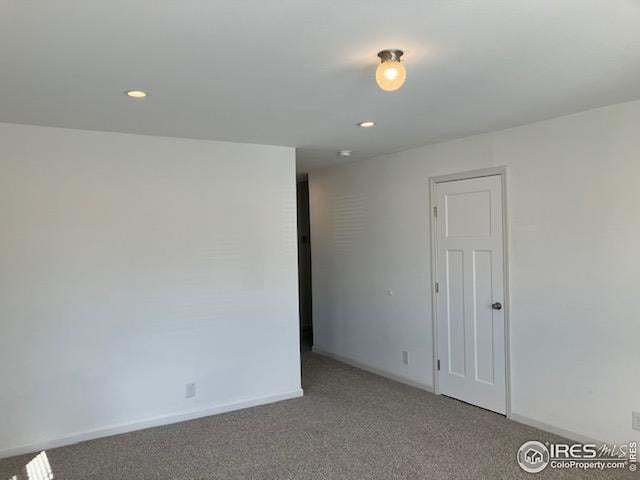 spare room with recessed lighting, carpet flooring, and baseboards