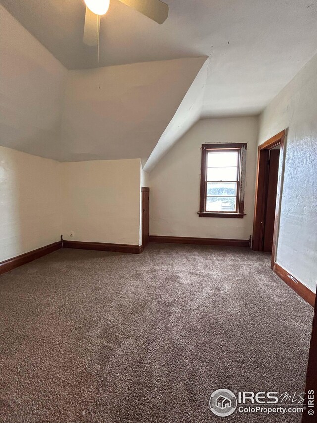 additional living space featuring ceiling fan, carpet floors, and lofted ceiling