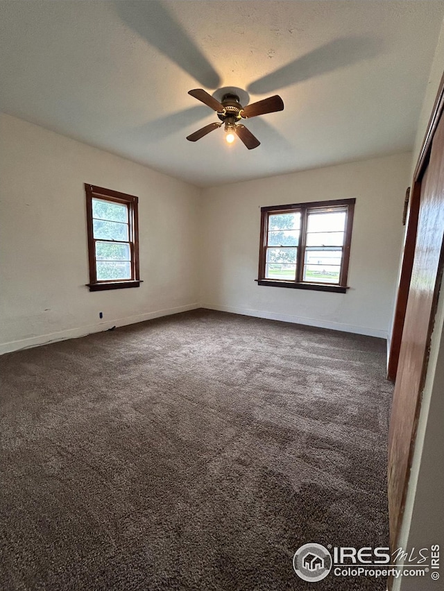 spare room featuring ceiling fan, carpet floors, and a textured ceiling