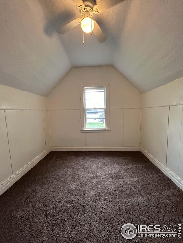 additional living space featuring carpet, lofted ceiling, ceiling fan, and a textured ceiling