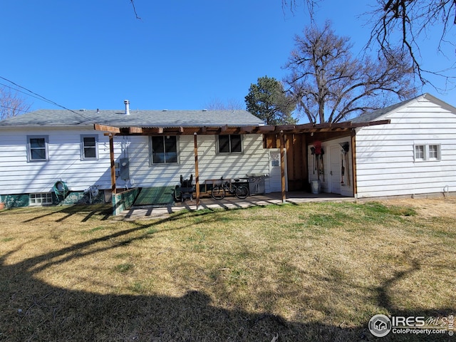 rear view of house featuring a patio and a yard