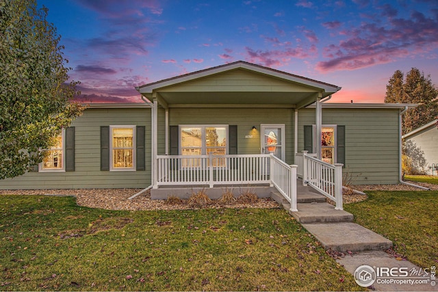 view of front of home with a yard and a porch