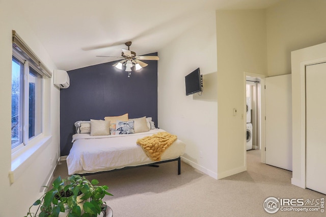 bedroom with light colored carpet, a wall mounted AC, a ceiling fan, stacked washing maching and dryer, and baseboards