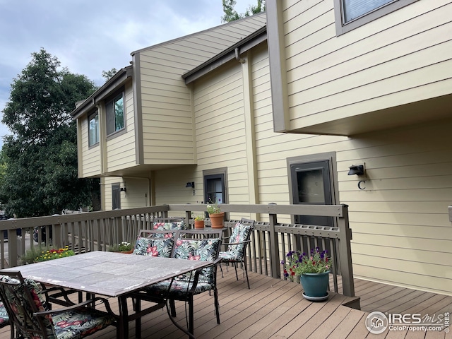 wooden deck featuring outdoor dining area