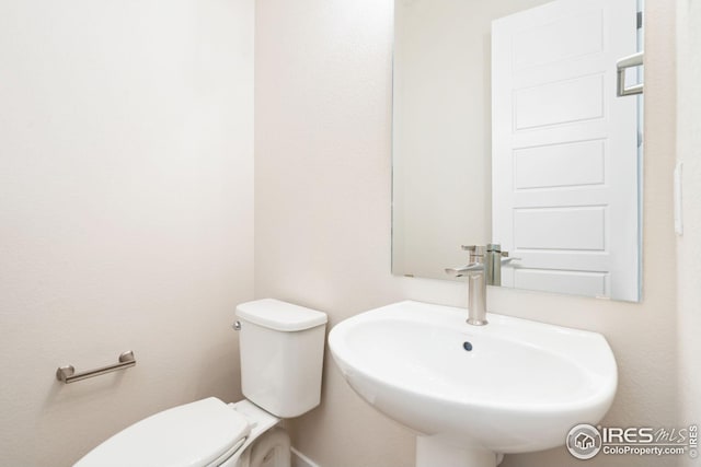 bathroom with toilet and sink