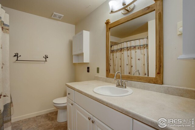 bathroom with toilet and vanity