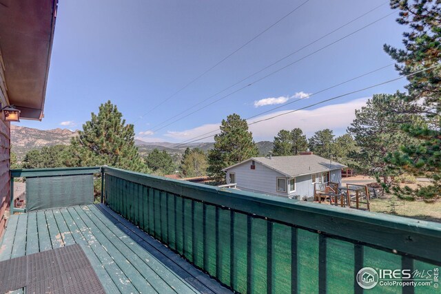 wooden deck featuring a mountain view