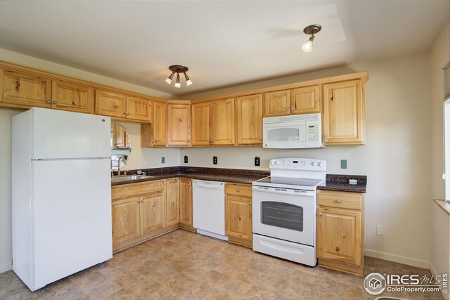 kitchen featuring white appliances and sink