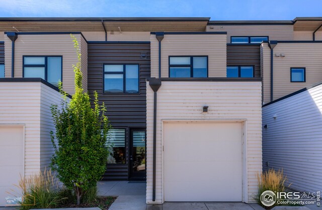 rear view of house with an attached garage
