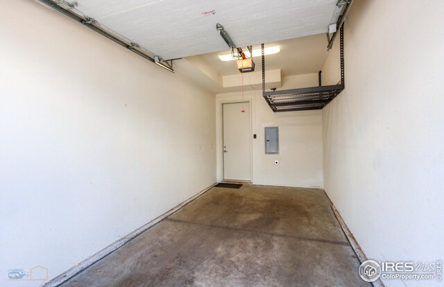 garage with electric panel and a garage door opener