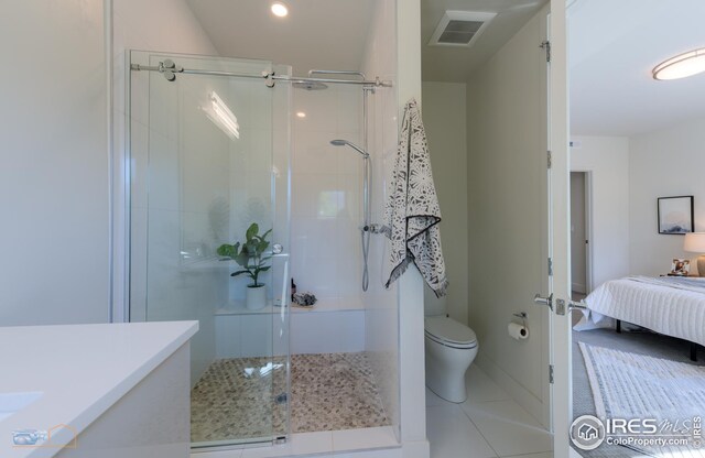 ensuite bathroom featuring visible vents, toilet, a stall shower, and ensuite bath