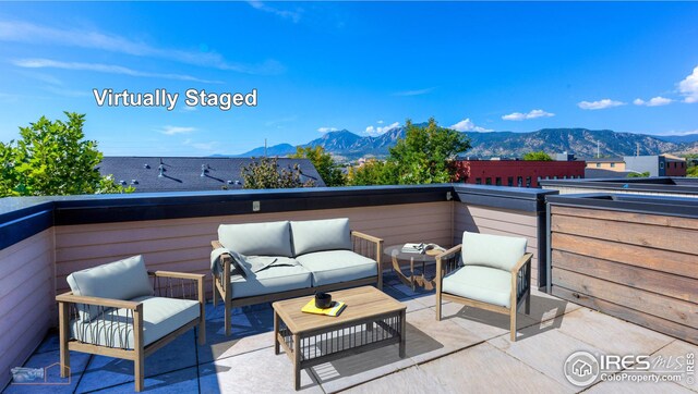view of patio with a mountain view, an outdoor hangout area, and a balcony