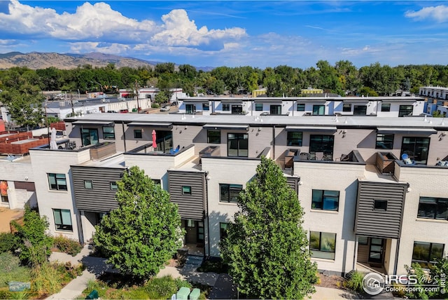 view of building exterior with a mountain view and a residential view