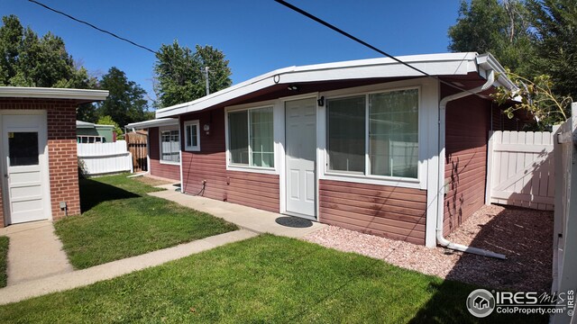 view of side of home featuring a yard