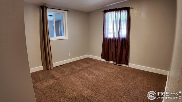 unfurnished room with carpet floors