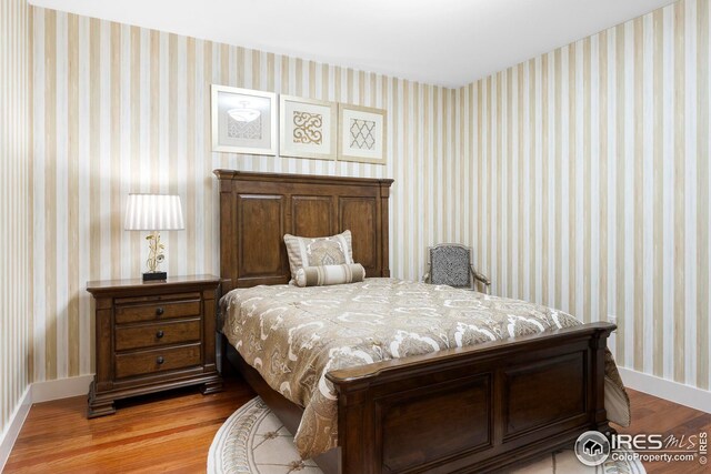 1155 Canyon Blvd Unit 205, Boulder, CO 80302 - bedroom with wallpapered walls, wood finished floors, and baseboards