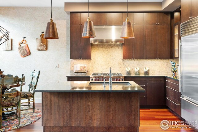 1155 Canyon Blvd Unit 205, Boulder, CO 80302 - kitchen with wall chimney exhaust hood, built in fridge, wood finished floors, and a sink