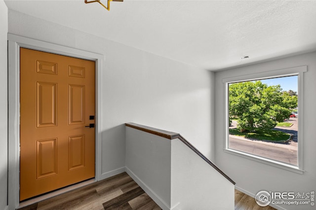 interior space with a textured ceiling and hardwood / wood-style flooring