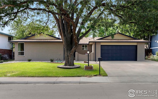 ranch-style home with a front yard and a garage