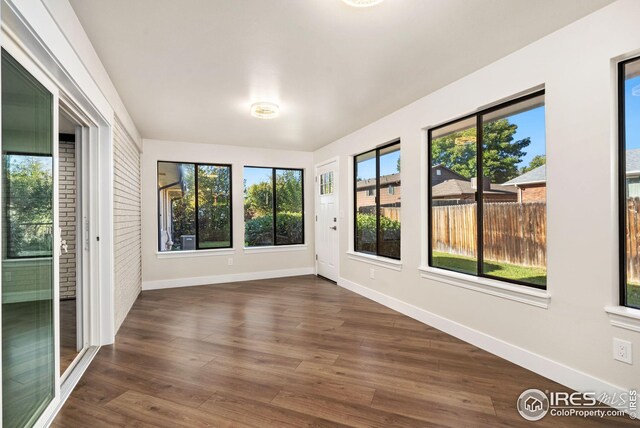 unfurnished room featuring dark wood-type flooring