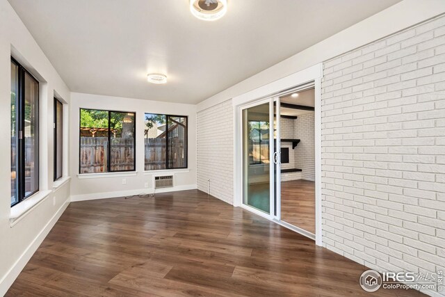 unfurnished sunroom featuring a wall unit AC